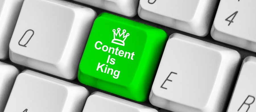 Green content is king key on the white computer keyboard.